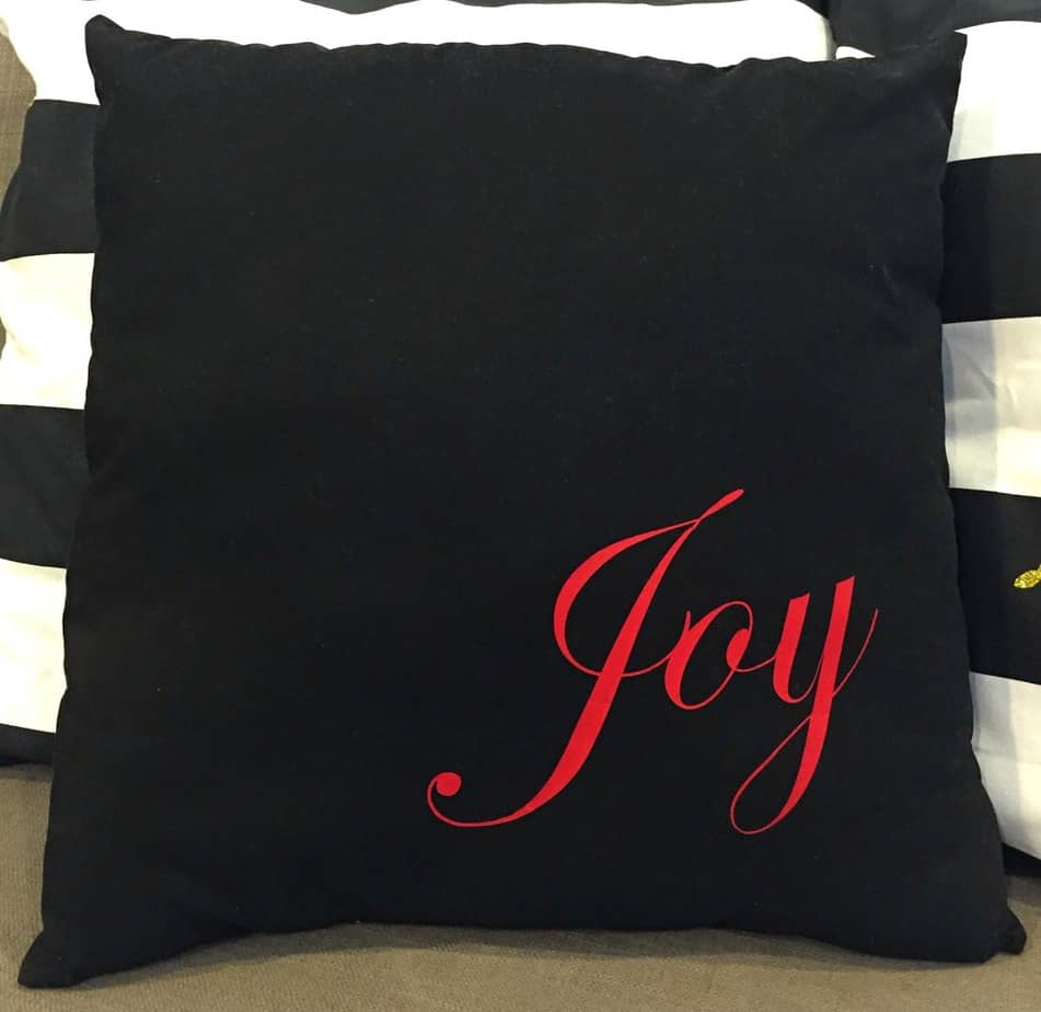 Finished easy Cricut Christmas pillow with Joy in Iron-on.