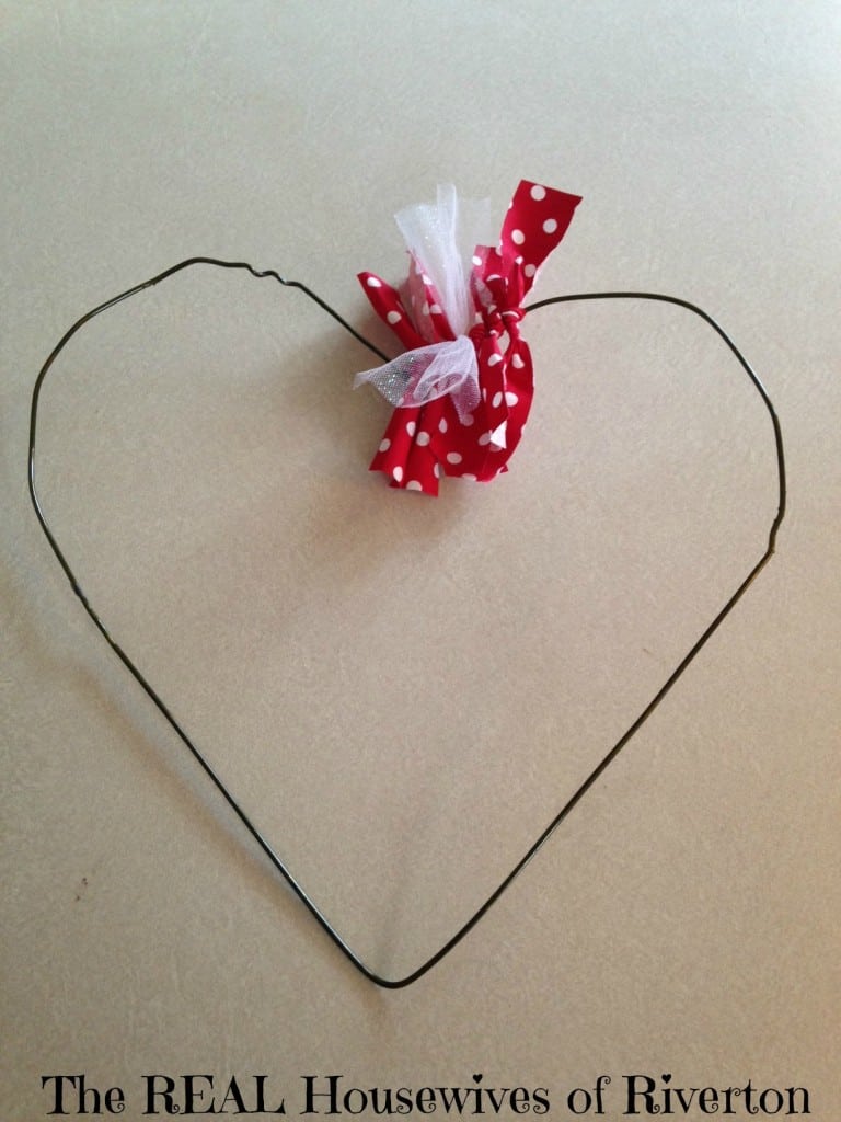 Metal heart wreath form with fabric ties started.